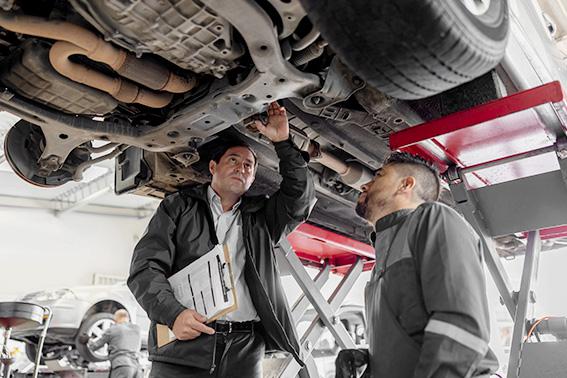 Foreman supervising the work of a mechanic